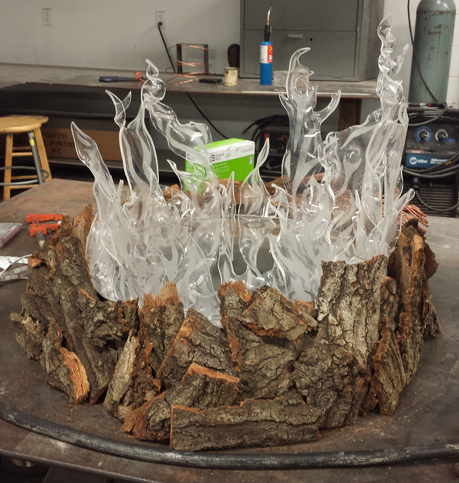 "Cool to the Touch" Heat-warped & sandblasted plexiglass flames with bark added around the base