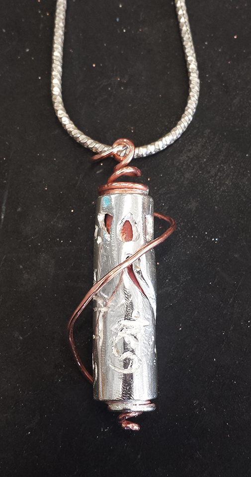 Closeup of Silver & Copper Spinning Prayer Pendant