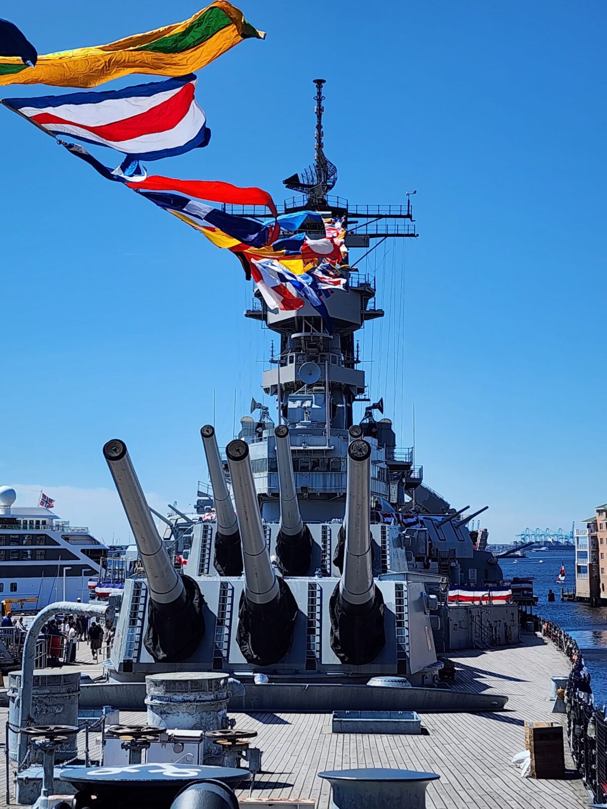 Guns on the deck of the U.S.S. Wisconsin decorated in flags in Norfolk, VA